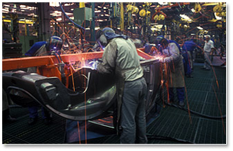 welders on a manufacturing line for truck chassis production
